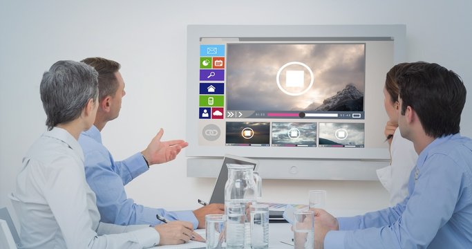 Composite image of attentive business team during a conference