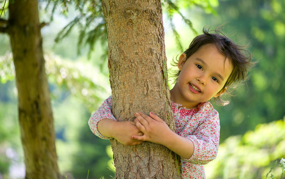 Little Girl Hugging The Tree