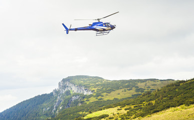 Fototapeta na wymiar helicopter on mountain landscape