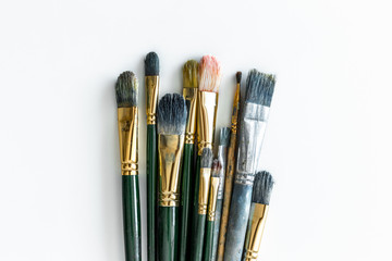 Different kinds of paint brushes on white background