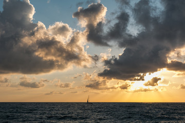 Sailboat in the sea at sunset