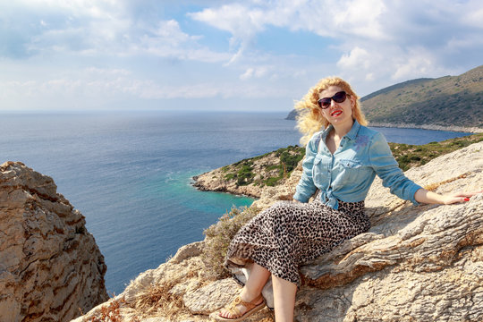 Blonde woman in the mountains of aegean sea
