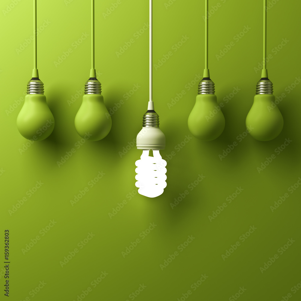 Leinwandbilder one hanging energy saving light bulb glowing different standing out from unlit incandescent bulbs wi