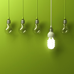 One hanging energy saving light bulb glowing different standing out from unlit incandescent bulbs with reflection on green background, leadership and different creative idea concept. 3D rendering.