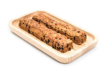 Chocolate chip stick bread with wood plate on white background.
