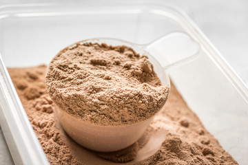 nutrition for workout with protein cocktail powder on stone background close up