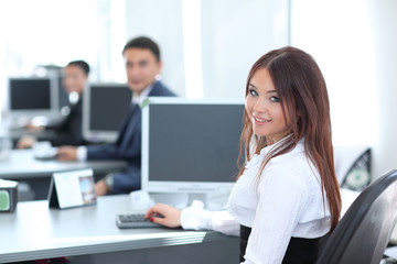 Beautiful young woman looking at camera with smile at the modern