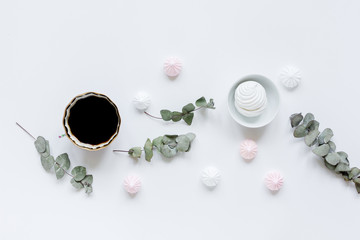 woman desk with plant and marsh-mallow in spring desing on white background flat lay