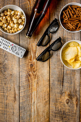 home party with TV watching, snacks and beer on wooden background top view mock up