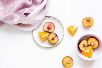 tropical peach and orange fruits for fresh juice with towel white background top view space for text