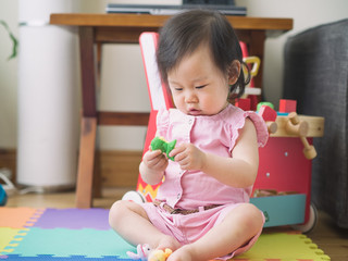 baby girl playing puppet at home