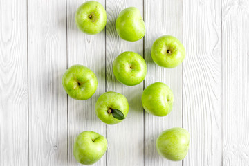 Fototapeta na wymiar ripe green apples white table background top view
