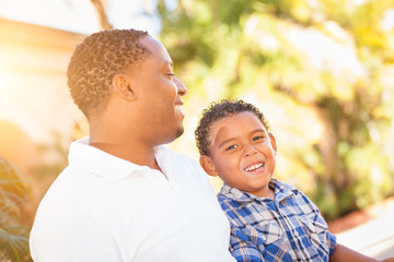 Obraz premium Mixed Race Son and African American Father Playing Outdoors Together.