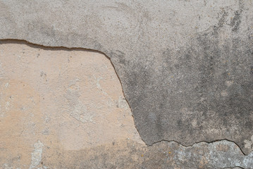 old chipped plaster on the concrete wall, gray background, texture