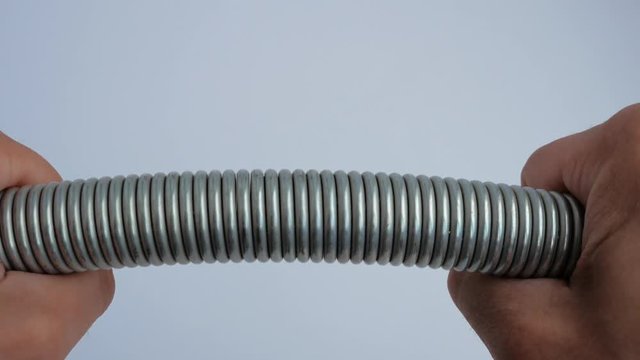 Man bends the spring with his hands