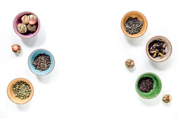 herbs in colorful bowls to make tea on white table background top view mock-up