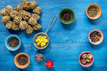 Different kinds of herbal tea on blue background top view
