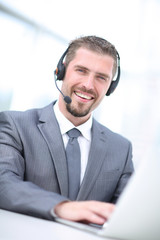Portrait of  a businessman working at his desk with headset and 