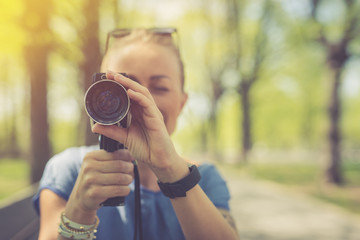 Summer. Young beautiful woman with vintage camera