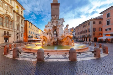  Fountain of the Four Rivers on the famous Piazza Navona Square during morning blue hour, Rome, Italy. © Kavalenkava