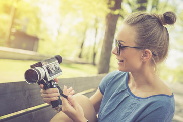 Summer. Young beautiful woman with vintage camera