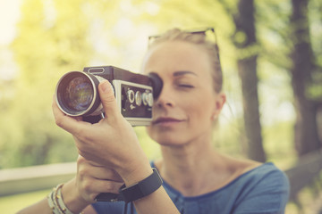 Summer. Young beautiful woman with vintage camera