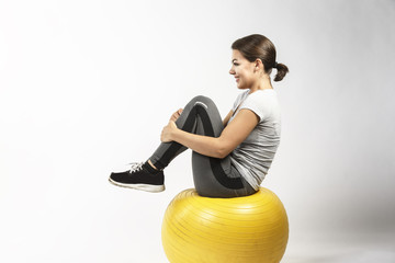 Beautiful Model doing exercise on ball
