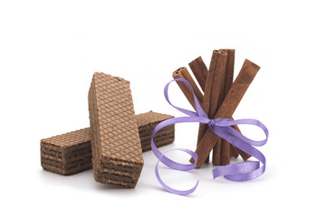 Wafers and cinnamon on a white background