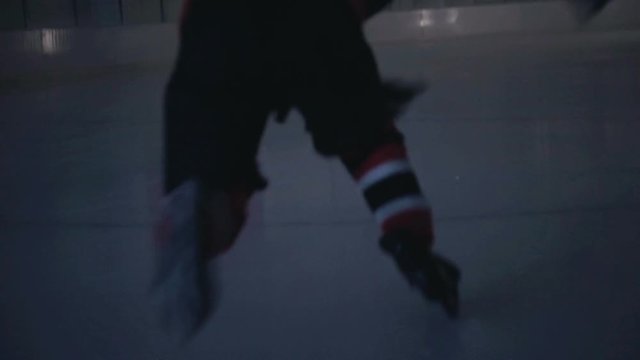 Ice hockey player rides on ice in the dark