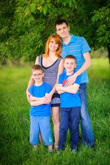 Fototapeta premium happy family on walk in the park, amicably embrace and smile