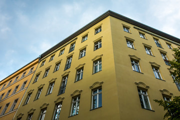 low angle view of yellow facaded apartment house