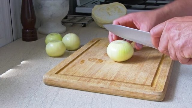 man chopping vegetables in the kitchen
