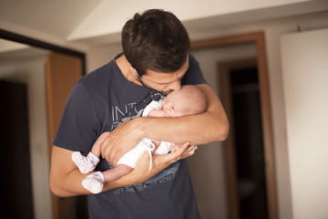 Newborn baby in father's arms