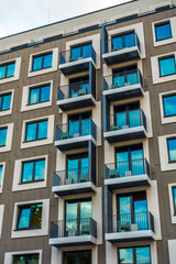 grey facaded apartment house with cube formed windows