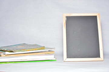 Fototapeta premium Black board and book isolated on white background