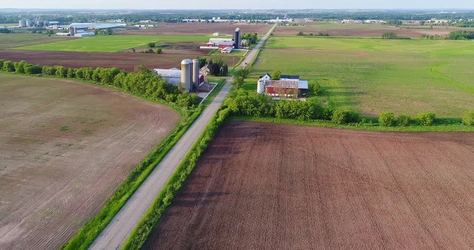 Scenic flyover of Wisconsin country road with Farms and fields.
