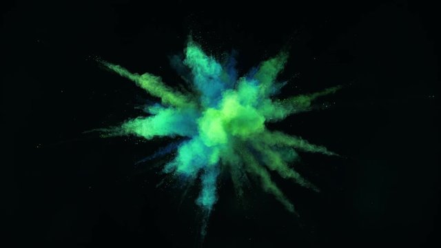 Colorful powder/particles fly after being exploded against black background. Shot with high speed camera, phantom flex 4K. Slow Motion. 