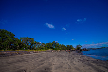 Beautiful view to Rangitoto Island from Karaka Bay Beach Auckland New Zealand in a blue sky in sunny day