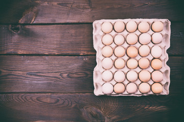 Raw chicken eggs in a paper tray