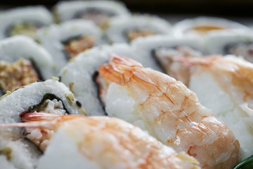 Horizontally placed shrimp sushi and rolls sold in box 