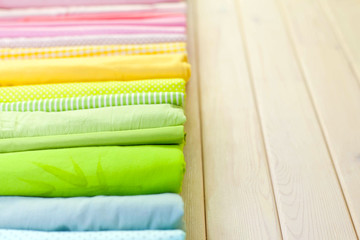 Cotton colored fabric. Background of white wood.