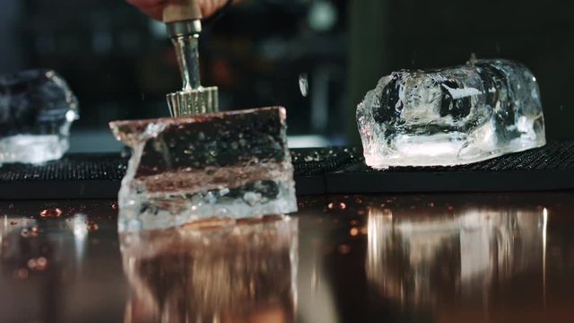 Slow motion process of ice cracking at bar counter background