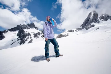 Foto op Plexiglas Climber breathing with mini portable oxygen cylinger to avoid and treat Altitude Sickness synptom © IamJoyful