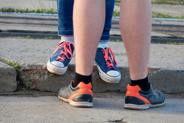 Male and female legs. Younge love couple in the street