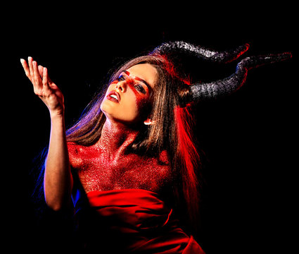 Mad satan woman on black magic ritual of hell. Witch reincarnation mythical creature Sabbath. Devil absorbing soul Halloween. Zodiac Capricorn Aries. Make-up for night club for demon inflicts damage.