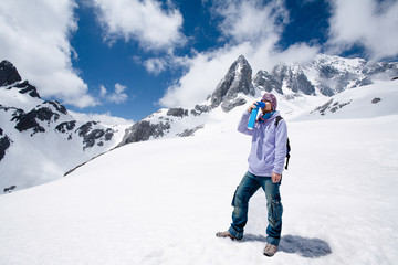 Fototapeta na wymiar Climber breathing with mini portable oxygen cylinger to avoid and treat Altitude Sickness synptom