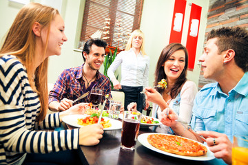 Four Friends Having Lunch At A Restaurant