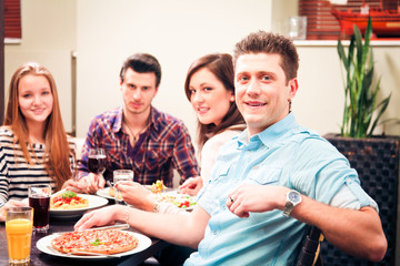Four Friends Having Lunch At A Restaurant
