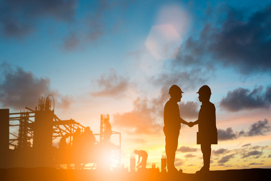 silhouette engineer shake hand