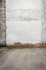 Broken old white plaster brick wall